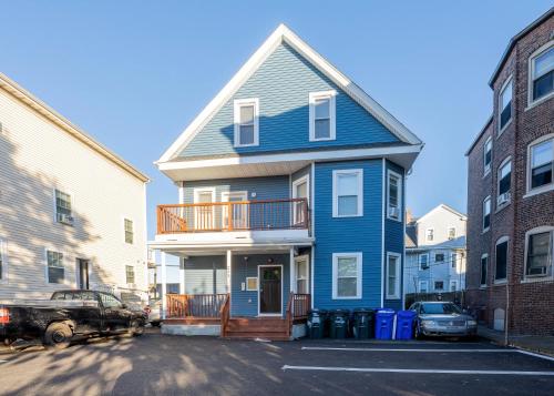 a blue house with a truck parked in front of it at 233-3 - 4BR Boston - Comfortable Family Stay near Park Zoo in Boston