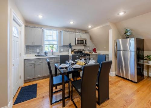 a kitchen with a table with chairs and a refrigerator at 233-3 - 4BR Boston - Comfortable Family Stay near Park Zoo in Boston