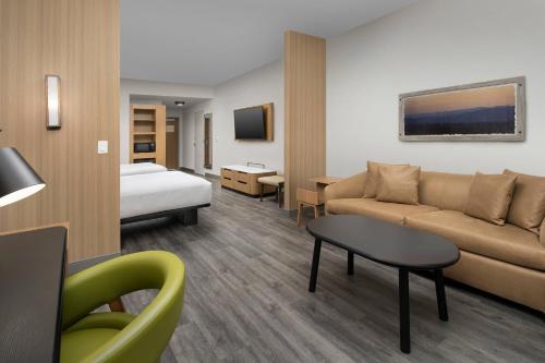 a hotel room with a couch and a bed at Fairfield Inn & Suites by Marriott Gainesville I-75 in Gainesville