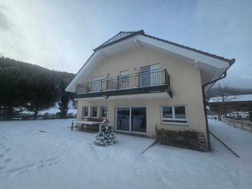 a house with a christmas tree in the snow at quiet and central Luxury Villa "JUWEL" with Sauna, at Ski slope! in Sankt Michael im Lungau