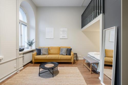 a living room with a couch and a table at "Hämeenkatu" - Renovated Loft at the BEST location, Hosted by 2ndhomes in Tampere