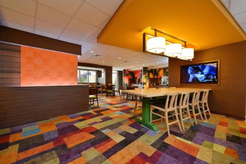 a dining room with a table and chairs on a colorful floor at Fairfield Inn & Suites by Marriott Elmira Corning in Horseheads
