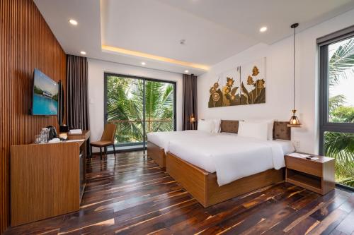 a bedroom with a large white bed and a desk at Langco Bay Retreat in Lang Co