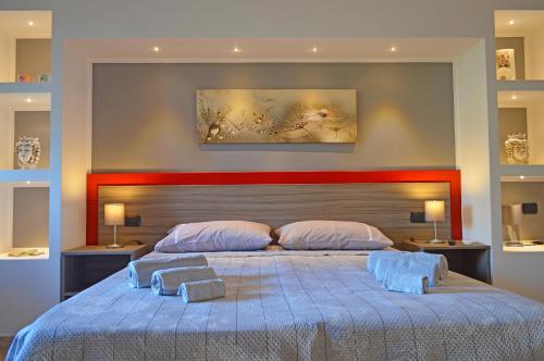 a bedroom with a large bed with two towels on it at House Paradise Amedeo in Bauso