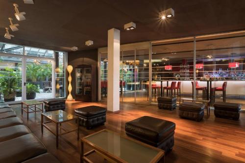a lobby of a restaurant with a bar at Four Points Sheraton Bolzano Bozen in Bolzano