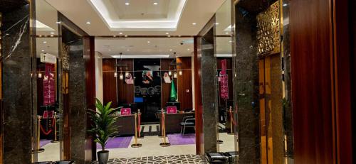 a lobby of a store with a glass door with a plant at Maysan Rehab Al Mysk Hotel in Al Madinah