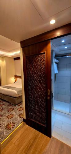 a door leading to a bedroom with a bed at Maysan Rehab Al Mysk Hotel in Al Madinah