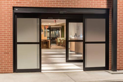 an open door into a brick building with glass at Fairfield Inn & Suites by Marriott Jasper in Jasper
