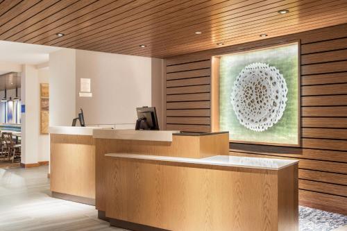 a lobby with a reception desk with a painting on the wall at Fairfield Inn & Suites by Marriott Jasper in Jasper
