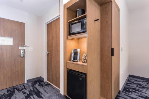 a small room with a tv and a cabinet at Fairfield Inn & Suites by Marriott Jasper in Jasper
