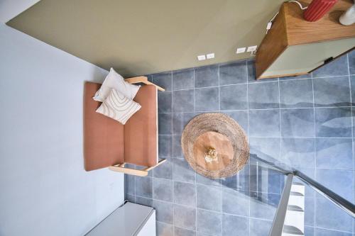 a room with a staircase with blue tiled walls at Le Coquebert - Studio in Reims
