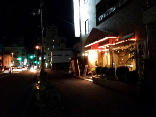an empty city street at night with a building at Uwajima Regent Hotel in Uwajima