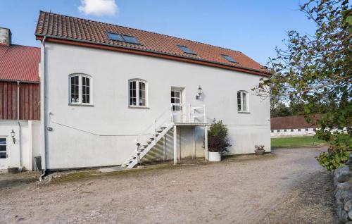 a white building with a staircase in front of it at Slots Lejlighed in Skanderborg