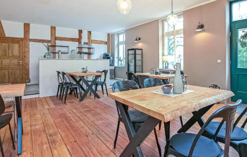 a restaurant with wooden tables and chairs in a room at Ferienwohnung Ankershagen in Friedrichsfeld