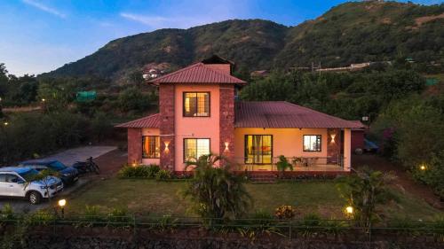 a house with a car parked in front of it at Lifeline Villas- Backwater Breeze Valley View Luxurious Infinity Pool Villa With Huge Open Area in Mahabaleshwar