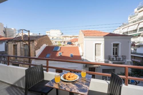 a table with a plate of food on a balcony at Amara Local Experience in Chania Town