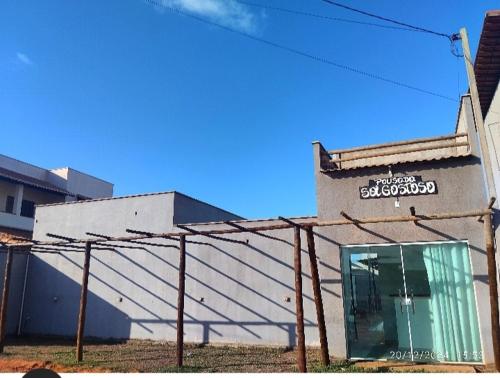 a building with a sign on the side of it at Pousada Sol Gostoso in São Miguel do Gostoso
