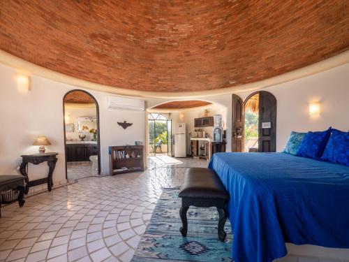 a bedroom with a large bed and a living room at Romantic Casa Rumi overlooking the Sea in Sayulita