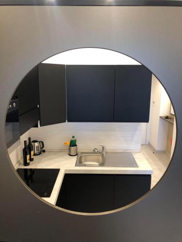 a kitchen with a round mirror over a sink at Domus Aurelia in Rome