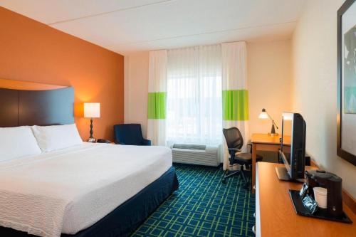 a hotel room with a bed and a desk with a television at Fairfield Inn & Suites Huntingdon Raystown Lake in Huntingdon