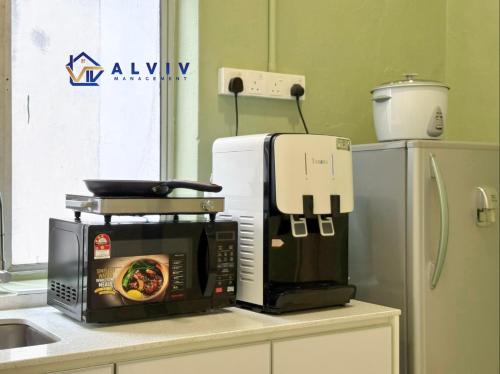 a microwave sitting on top of a kitchen counter at NEW! I 2BR I Playground Kids Friendly I 5-11pax I 10min walk Jonker I BY Alviv in Melaka