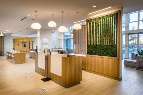 a lobby of an office with a green wall at Element Bend in Bend