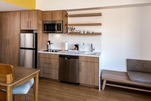 a kitchen with a sink and a refrigerator at Element Bend in Bend
