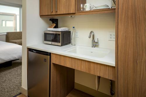 a kitchen with a sink and a microwave at Element Bend in Bend