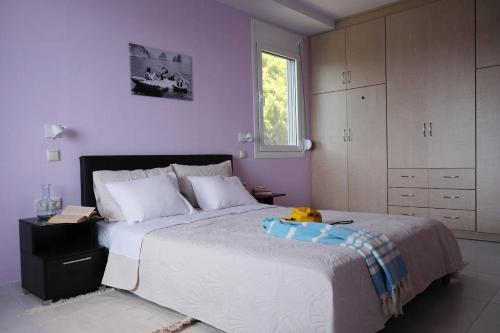a bedroom with a large bed with a stuffed animal on it at Kassandra in Sivota
