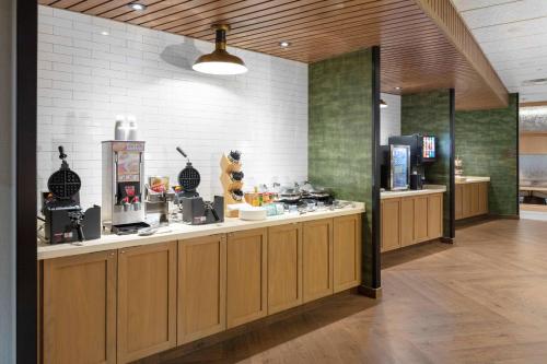 a restaurant with a counter with food on it at Fairfield by Marriott Inn & Suites Medford in Medford