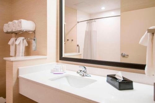 a bathroom with a sink and a large mirror at Fairfield Inn & Suites by Marriott San Antonio Brooks City Base in San Antonio