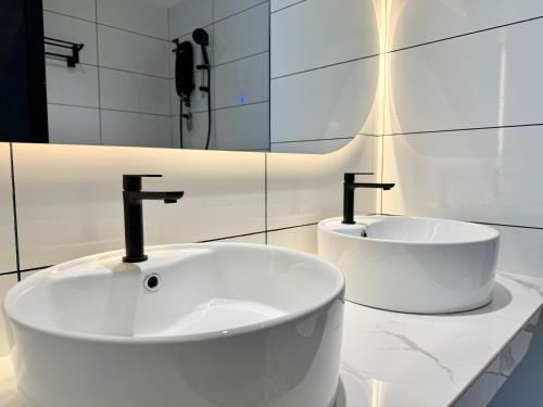 a white bathroom with a tub and a sink at Century Suria Aparment Langkawi by Zervin in Kuah
