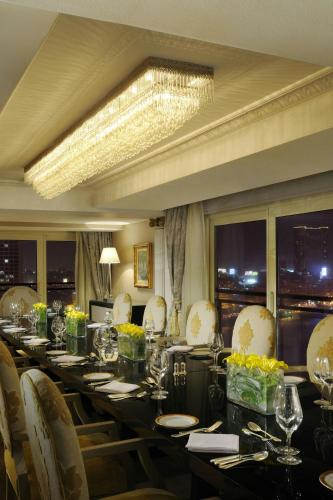 a long dining room with a long table and chairs at Cairo Marriott Hotel & Omar Khayyam Casino in Cairo