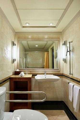 a bathroom with a sink and a large mirror at Cairo Marriott Hotel & Omar Khayyam Casino in Cairo