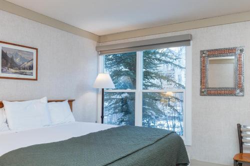 a bedroom with a bed and a large window at Mountainside Inn 201 by Alpine Lodging Telluride in Telluride