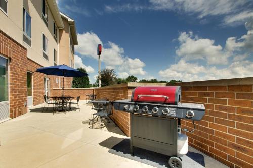 a grill on a patio with a table and umbrella at Fairfield Inn & Suites by Marriott Ottawa Starved Rock Area in Ottawa
