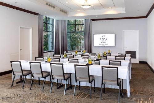 a conference room with a large white table and chairs at Delta Hotels by Marriott Whistler Village Suites in Whistler