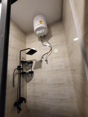 a light in the corner of a room with a floor at Accra Apartments in Accra