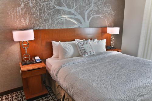 a bedroom with a bed and two lamps on tables at Fairfield Inn & Suites by Marriott Savannah Midtown in Savannah
