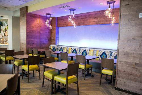 a dining room with tables and yellow chairs at Fairfield Inn & Suites by Marriott Savannah Midtown in Savannah