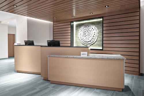 an office lobby with a reception desk and a picture at Fairfield Inn & Suites by Marriott Lake Geneva in Lake Geneva