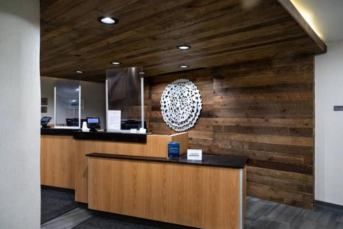 a lobby with a wooden wall with a reception desk at Fairfield by Marriott Inn & Suites Louisville Airport in Louisville