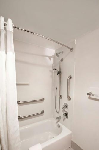 a white bathroom with a shower and a tub at Fairfield by Marriott Inn & Suites Louisville Airport in Louisville
