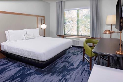 a hotel room with a bed and a desk and a chair at Fairfield Inn & Suites by Marriott Memphis Collierville in Collierville