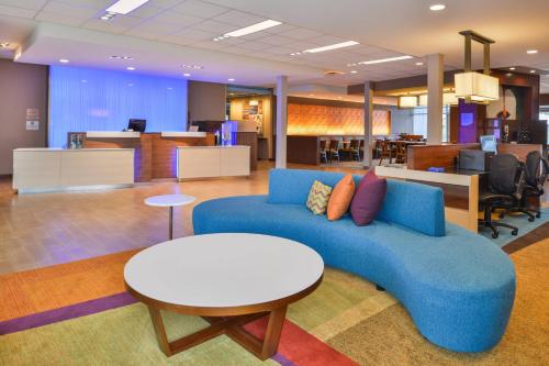 a living room with a blue couch and a table at Fairfield Inn & Suites by Marriott Eugene East/Springfield in Eugene