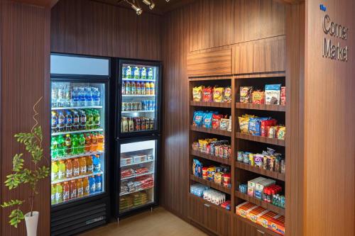 a grocery store aisle with two large refrigerators at Fairfield Inn & Suites by Marriott North Bergen in North Bergen