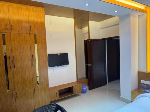 a bedroom with a large mirror and a bed and a tv at The Castle Inn in Dhaka