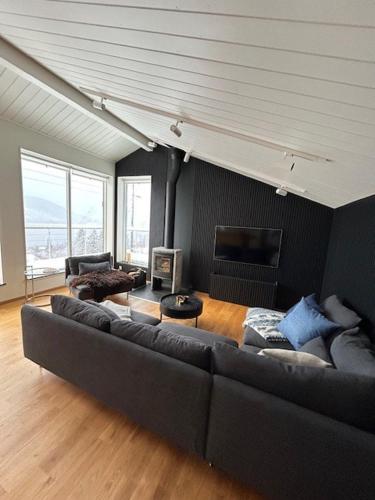 a living room with a large couch in a room at Architect villa with a view in Åre