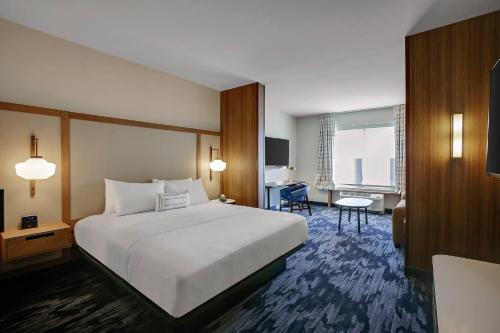 a hotel room with a large bed and a desk at Fairfield Inn & Suites Bardstown in Bardstown