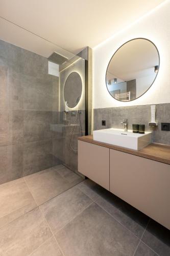 a bathroom with a sink and a mirror at Appartements Kuckuck Leogang in Leogang